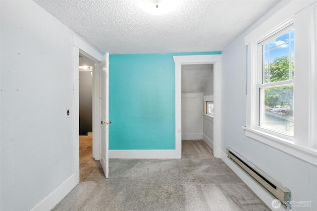 4061 E Howe St, Tacoma, WA 98404 - unfurnished bedroom with a baseboard radiator, a textured ceiling, carpet flooring, multiple windows, and a closet