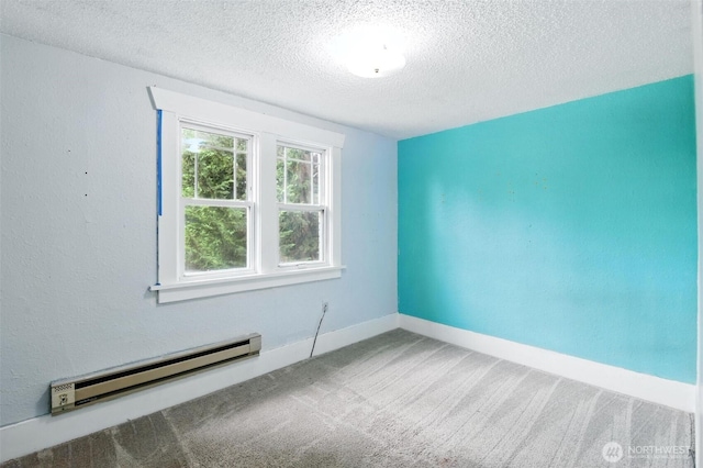 4061 E Howe St, Tacoma, WA 98404 - empty room with a baseboard radiator, a textured ceiling, and carpet
