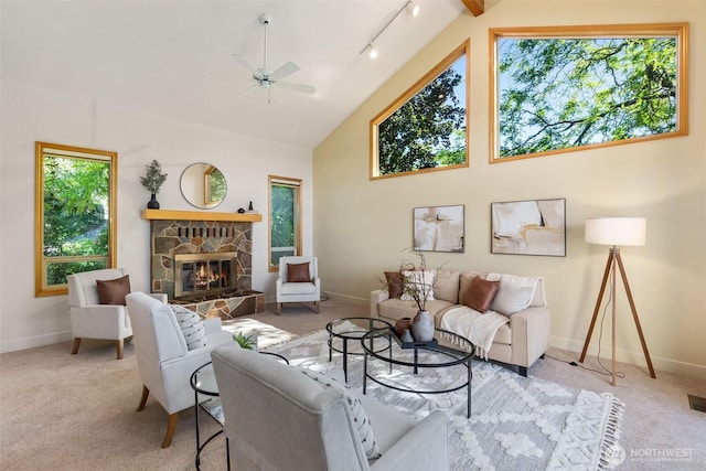 6701 Macintosh Ct SE, Olympia, WA 98513 - carpeted living room featuring a ceiling fan, a stone fireplace, high vaulted ceiling, and track lighting