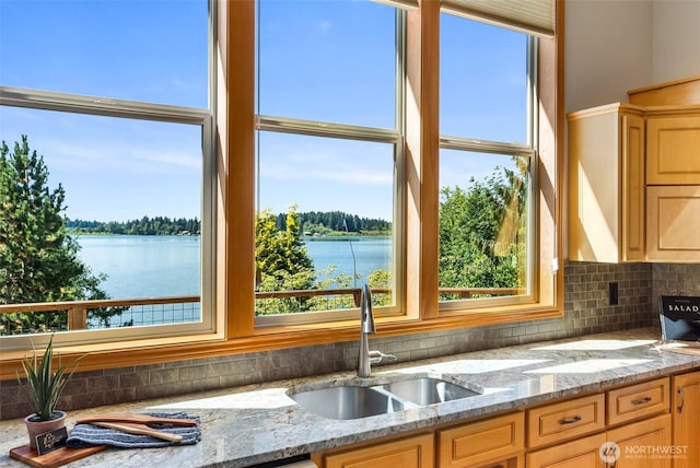 6701 Macintosh Ct SE, Olympia, WA 98513 - kitchen with tasteful backsplash, a water view, light brown cabinetry, and light stone countertops