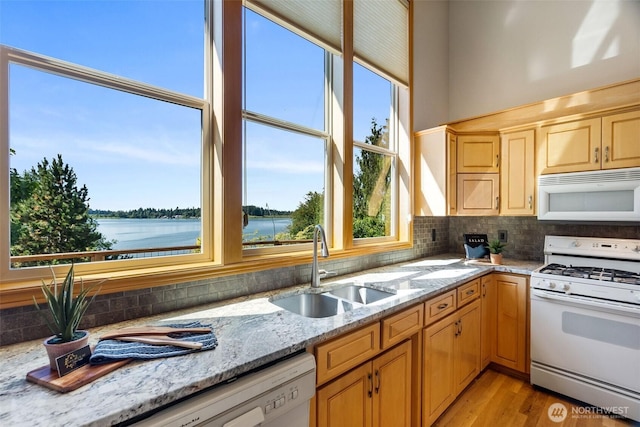 6701 Macintosh Ct SE, Olympia, WA 98513 - kitchen with white appliances, decorative backsplash, light brown cabinetry, and light stone countertops