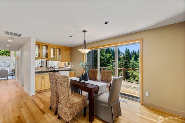 6701 Macintosh Ct SE, Olympia, WA 98513 - dining area with baseboards and light wood-style flooring