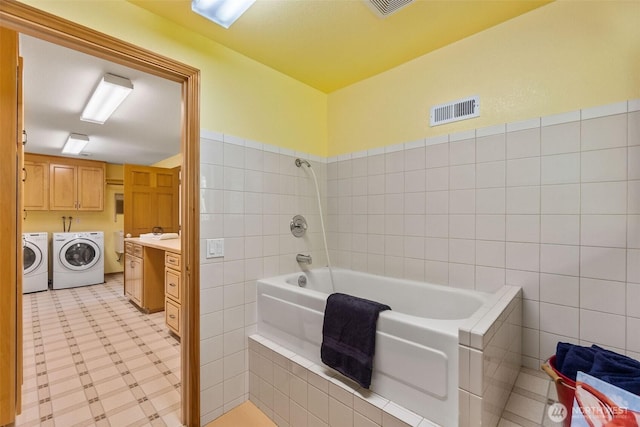 6701 Macintosh Ct SE, Olympia, WA 98513 - full bathroom featuring separate washer and dryer, vanity, and tile walls