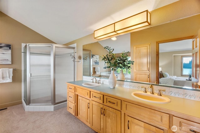 6701 Macintosh Ct SE, Olympia, WA 98513 - ensuite bathroom featuring double vanity, a shower stall, and lofted ceiling