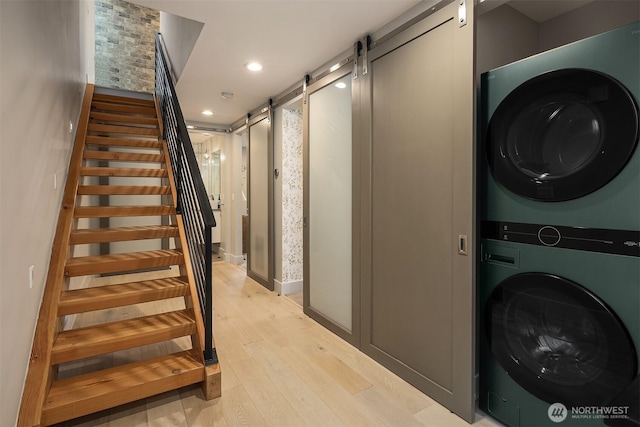1629 42nd Ave E Unit B, Seattle, WA 98112 - stairs featuring estacked washer and dryer, a barn door, recessed lighting, and wood finished floors