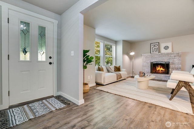 8106 186th Street Ct E, Puyallup, WA 98375 - foyer entrance featuring wood finished floors and a brick fireplace