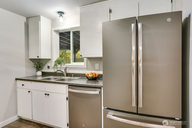 8106 186th Street Ct E, Puyallup, WA 98375 - kitchen featuring appliances with stainless steel finishes, dark countertops, and white cabinetry
