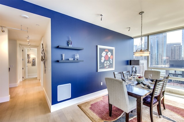 1521 2nd Ave Unit 2303, Seattle, WA 98101 - dining space featuring wood finished floors and a wall of windows