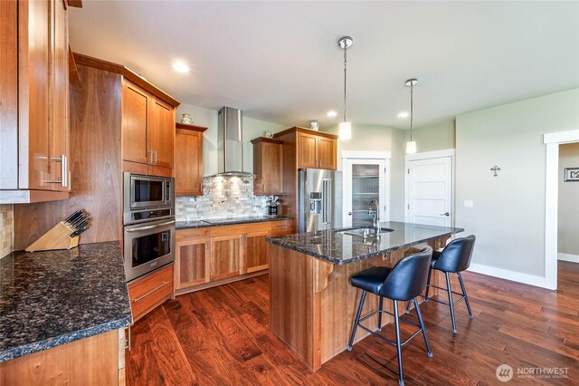 3516 Dianna Way, Wenatchee, WA 98801 - kitchen with stainless steel appliances, wall chimney exhaust hood, brown cabinets, dark wood finished floors, and recessed lighting