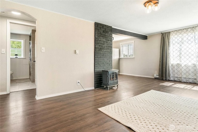 4476 Birch Bay Lynden Rd, Birch Bay, WA 98230 - living area featuring a wood stove, wood finished floors, healthy amount of natural light, ornamental molding, and arched walkways