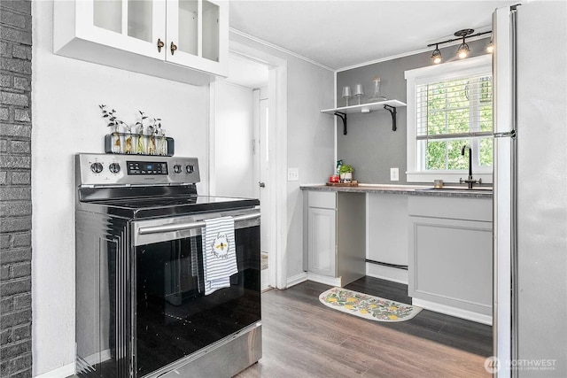 4476 Birch Bay Lynden Rd, Birch Bay, WA 98230 - kitchen with stainless steel range with electric stovetop, freestanding refrigerator, ornamental molding, dark wood-style flooring, and white cabinetry