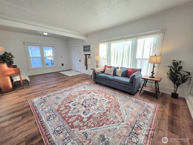 321 12th St, Raymond, WA 98577 - living room featuring a textured ceiling, wood finished floors, and crown molding