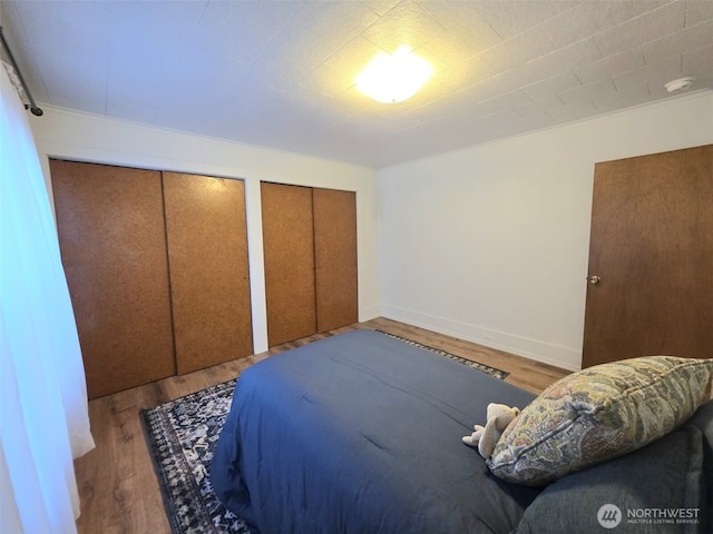 321 12th St, Raymond, WA 98577 - bedroom featuring wood finished floors and multiple closets