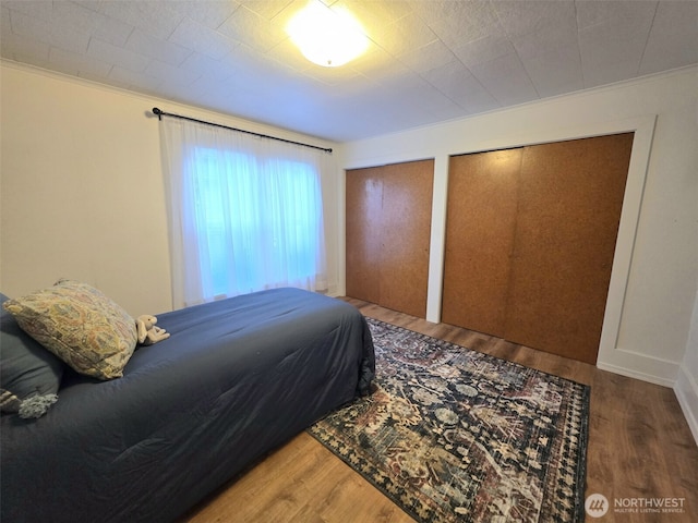 321 12th St, Raymond, WA 98577 - bedroom featuring two closets, wood finished floors, and crown molding