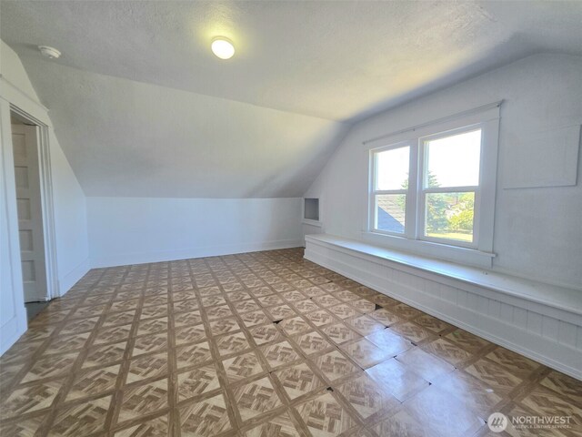 321 12th St, Raymond, WA 98577 - bonus room featuring lofted ceiling and a textured ceiling