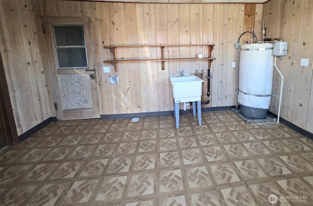 321 12th St, Raymond, WA 98577 - laundry room with strapped water heater and wood walls