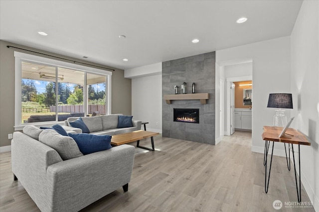 1427 114th Ave E, Edgewood, WA 98372 - living area featuring light wood finished floors, a fireplace, and recessed lighting