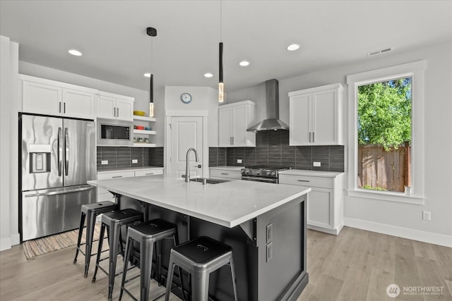 1427 114th Ave E, Edgewood, WA 98372 - kitchen featuring stainless steel appliances, open shelves, wall chimney range hood, tasteful backsplash, and white cabinets