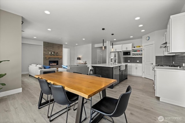 1427 114th Ave E, Edgewood, WA 98372 - dining room featuring recessed lighting, a fireplace, and light wood-type flooring