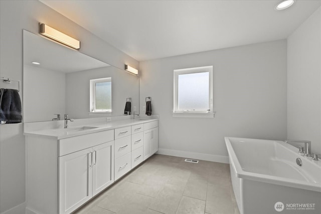 1427 114th Ave E, Edgewood, WA 98372 - bathroom with a soaking tub, double vanity, recessed lighting, and tile patterned flooring