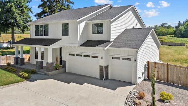 1427 114th Ave E, Edgewood, WA 98372 - modern farmhouse style home with roof with shingles, an attached garage, covered porch, board and batten siding, and concrete driveway