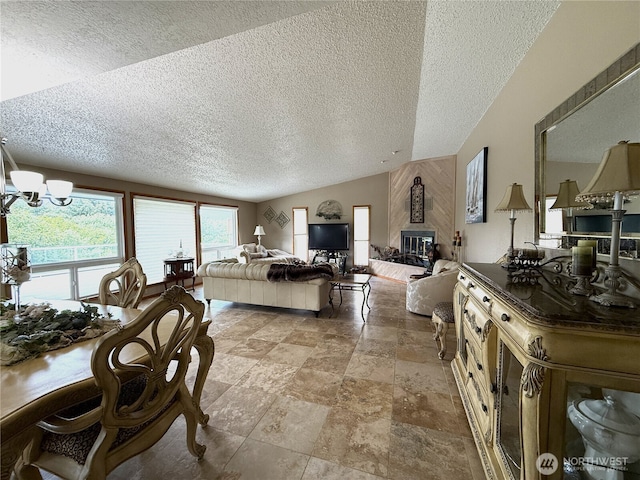 101 Sand Dune Ave NW, Ocean Shores, WA 98569 - living room with a textured ceiling, a chandelier, stone finish floors, a fireplace, and vaulted ceiling