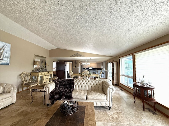 101 Sand Dune Ave NW, Ocean Shores, WA 98569 - living room with lofted ceiling, a textured ceiling, a chandelier, and light stone finish floors