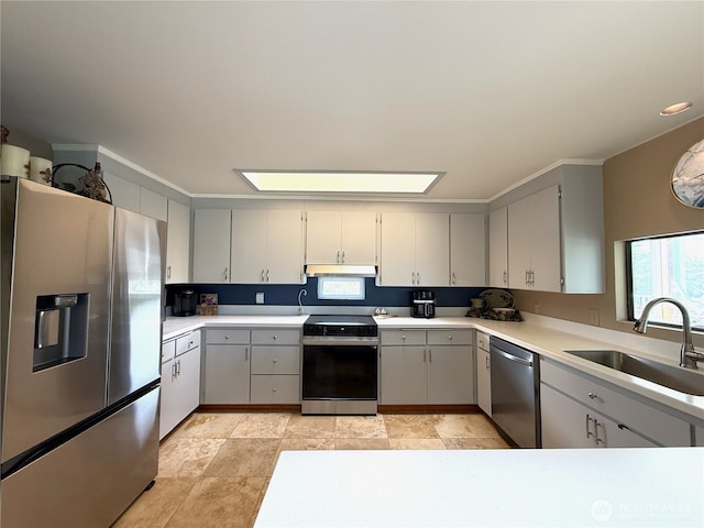 101 Sand Dune Ave NW, Ocean Shores, WA 98569 - kitchen with stainless steel appliances, gray cabinets, under cabinet range hood, and light countertops