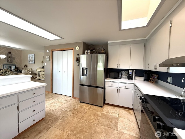 101 Sand Dune Ave NW, Ocean Shores, WA 98569 - kitchen featuring stainless steel refrigerator with ice dispenser, electric range, light countertops, and black microwave