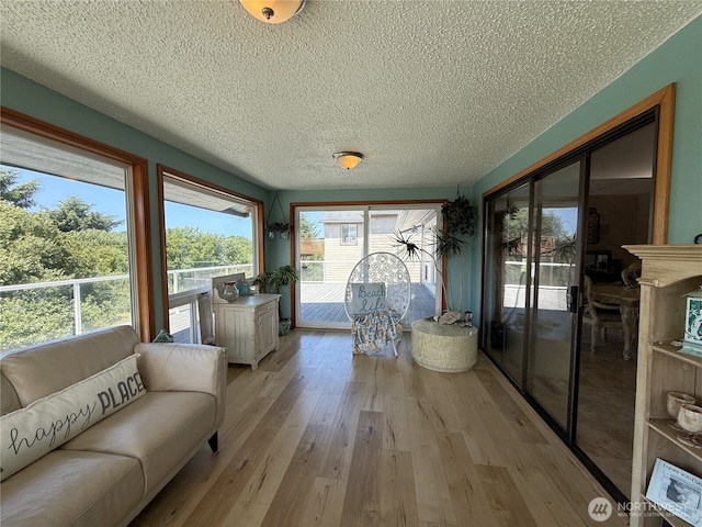 101 Sand Dune Ave NW, Ocean Shores, WA 98569 - sunroom featuring a textured ceiling and wood finished floors