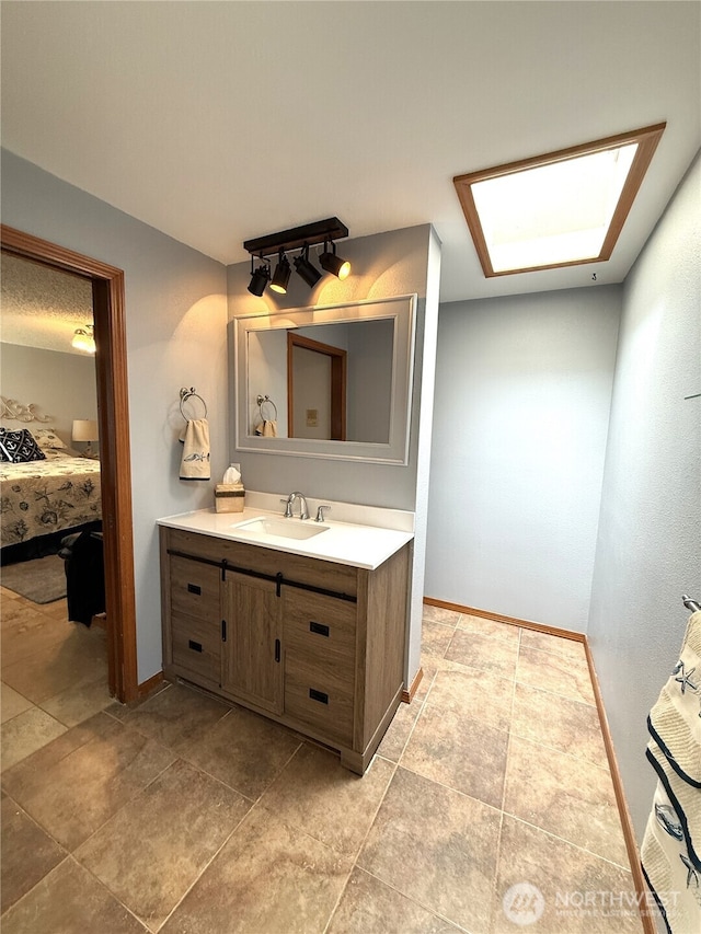 101 Sand Dune Ave NW, Ocean Shores, WA 98569 - bathroom featuring vanity, ensuite bathroom, and a skylight