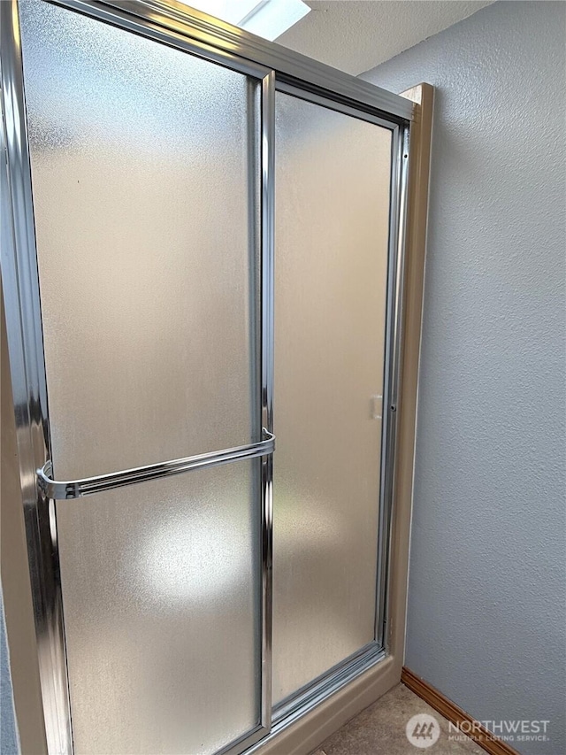 101 Sand Dune Ave NW, Ocean Shores, WA 98569 - bathroom with a shower with shower door and a textured wall