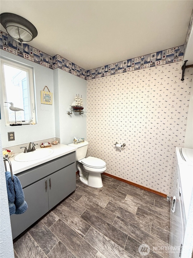 101 Sand Dune Ave NW, Ocean Shores, WA 98569 - bathroom featuring vanity, separate washer and dryer, and wood finish floors