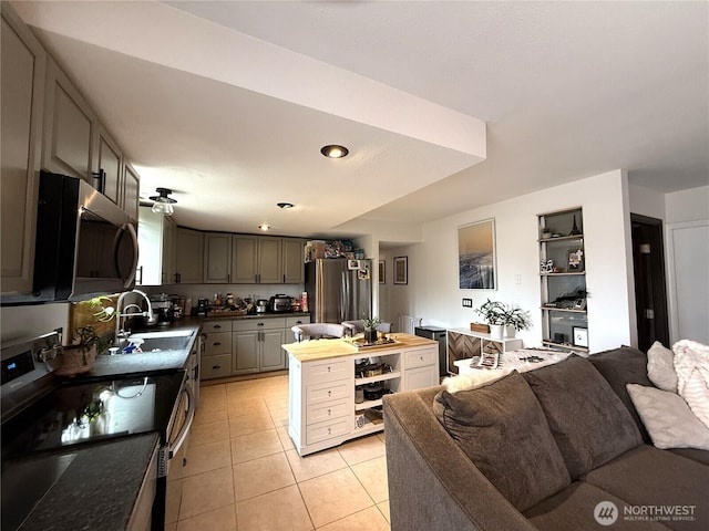 101 Sand Dune Ave NW, Ocean Shores, WA 98569 - kitchen with appliances with stainless steel finishes, light tile patterned floors, open floor plan, gray cabinets, and wooden counters