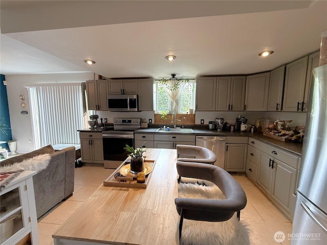 101 Sand Dune Ave NW, Ocean Shores, WA 98569 - kitchen with light tile patterned floors, appliances with stainless steel finishes, gray cabinetry, dark countertops, and recessed lighting