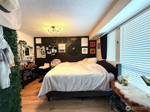 101 Sand Dune Ave NW, Ocean Shores, WA 98569 - bedroom featuring a textured ceiling and wood finished floors