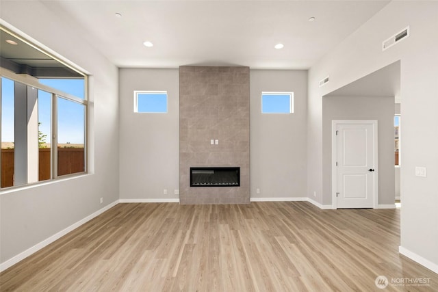 13931 178th St E Unit 39, Puyallup, WA 98374 - unfurnished living room featuring healthy amount of natural light, wood finished floors, a fireplace, and recessed lighting
