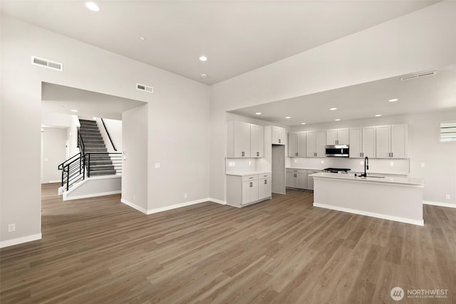 13931 178th St E Unit 39, Puyallup, WA 98374 - unfurnished living room featuring light wood-style floors, recessed lighting, and stairs