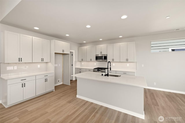13931 178th St E Unit 39, Puyallup, WA 98374 - kitchen with appliances with stainless steel finishes, tasteful backsplash, light wood-style flooring, and recessed lighting