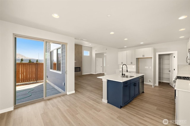 13931 178th St E Unit 39, Puyallup, WA 98374 - kitchen featuring appliances with stainless steel finishes, light wood-style flooring, white cabinetry, light countertops, and recessed lighting
