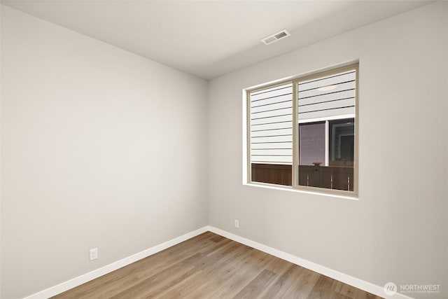 13931 178th St E Unit 39, Puyallup, WA 98374 - spare room featuring baseboards and wood finished floors
