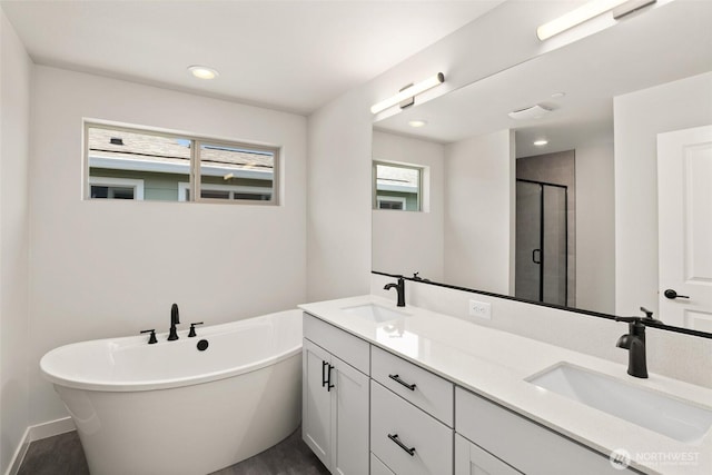 13931 178th St E Unit 39, Puyallup, WA 98374 - full bathroom with double vanity, a stall shower, a soaking tub, and recessed lighting