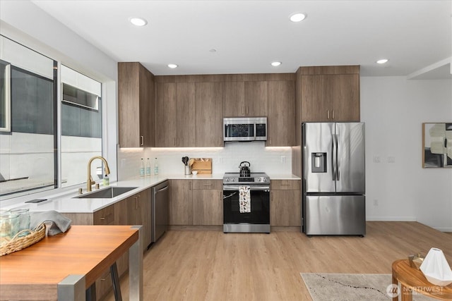 918 28th Ave S Unit B, Seattle, WA 98144 - kitchen featuring appliances with stainless steel finishes, light countertops, light wood-type flooring, and recessed lighting