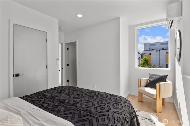 918 28th Ave S Unit B, Seattle, WA 98144 - bedroom featuring light wood-style flooring, a wall mounted air conditioner, and recessed lighting