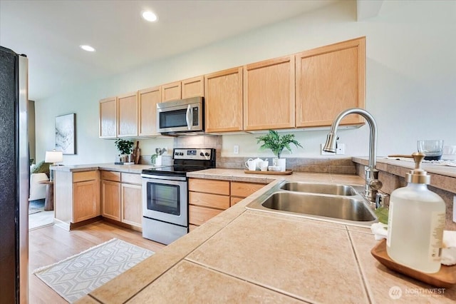 9411 18th Ave W Unit B, Everett, WA 98204 - kitchen featuring light brown cabinetry, appliances with stainless steel finishes, light countertops, a peninsula, and recessed lighting