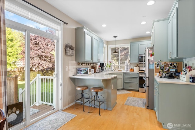 2060 Hammond Ave, Dupont, WA 98327 - kitchen with a peninsula, stainless steel microwave, plenty of natural light, backsplash, and recessed lighting