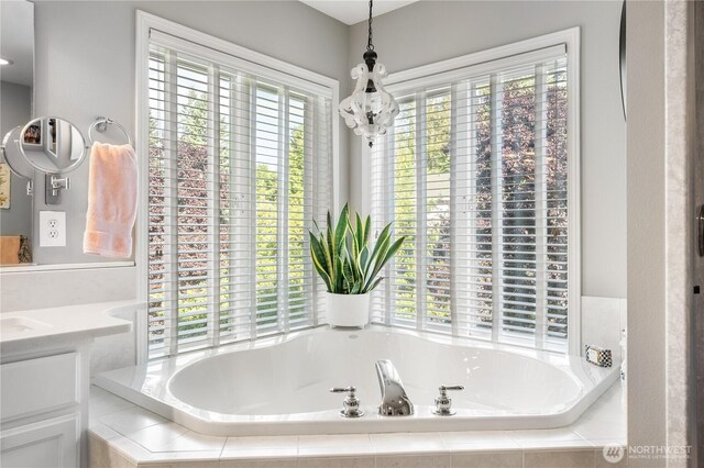 2060 Hammond Ave, Dupont, WA 98327 - bathroom with vanity, a garden tub, and a chandelier