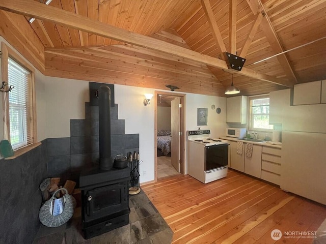 4 Ruger Rd, Oroville, WA 98844 - kitchen featuring wood ceiling, white appliances, light wood-style floors, a wood stove, and hanging light fixtures