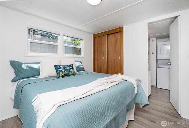 2500 Samish Way Unit 13, Bellingham, WA 98229 - bedroom with estacked washer and dryer, a closet, and wood finished floors