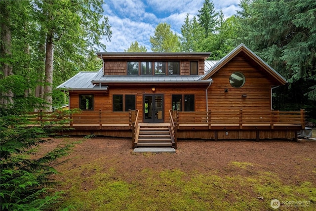 1692 Galbraith Ln, Bellingham, WA 98229 - rear view of house featuring a metal roof, french doors, a wooden deck, and a standing seam roof